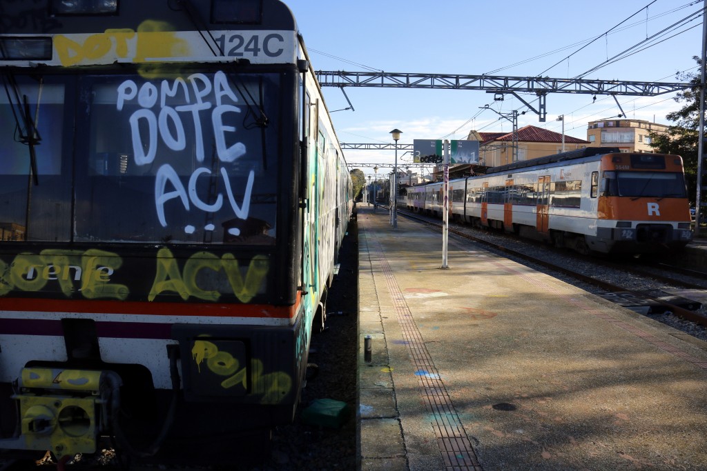 Pla general on es pot veure el tren de la R12 estacionat a Cervera que no ha pogut sortir perquè uns grafiters l'han pintat mentre arriba un altre tren de la mateixa línia en direcció Barcelona, el 7 de novembre de 2018. (Horitzontal)